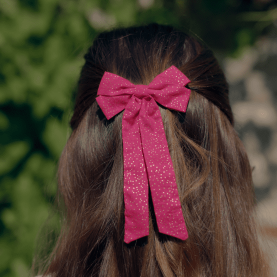 Barrette noeud ruban moyenne fuchsia pailleté